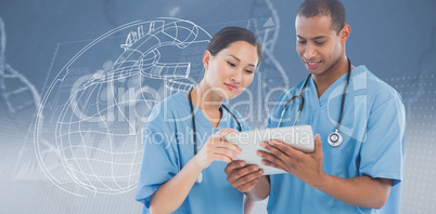 Composite image of surgeons looking at digital tablet in hospita