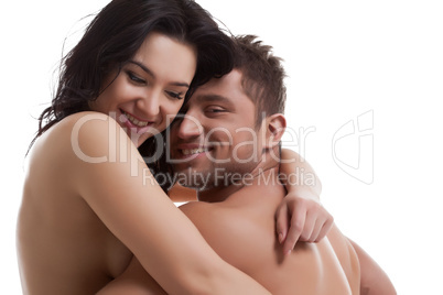 Smiling nude lovers hugging at camera