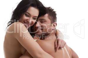 Smiling nude lovers hugging at camera