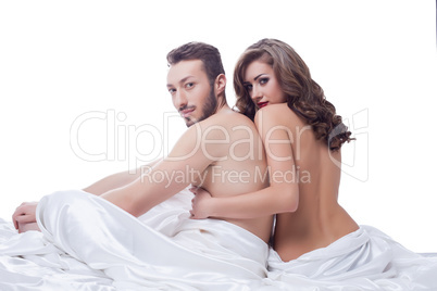 Two sexual partner posing naked in bed