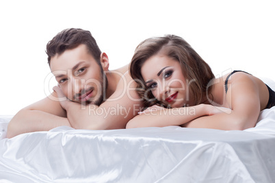 Attractive young sexual partners lying in bed