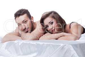 Attractive young sexual partners lying in bed