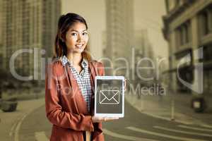 Composite image of smiling businesswoman showing a tablet