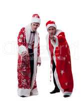 Cute young people posing dressed as Santa Claus