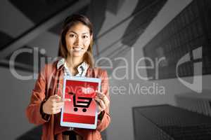 Composite image of smiling businesswoman pointing a tablet