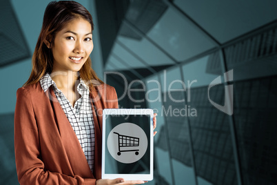 Composite image of smiling businesswoman showing a tablet