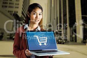 Composite image of smiling businesswoman showing a laptop