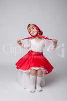 Sweet little ballerina posing in folk costume
