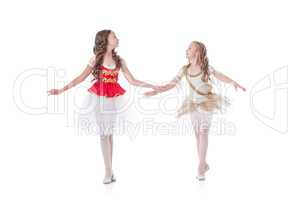 Two cute young ballerinas looking at each other