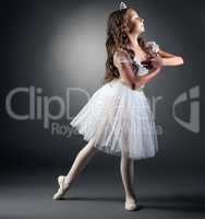 Side view of adorable little ballerina posing