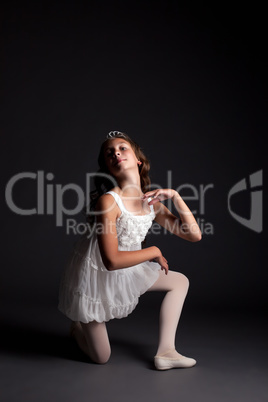 Image of smiling young ballerina posing in studio