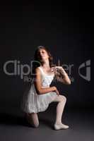 Image of smiling young ballerina posing in studio