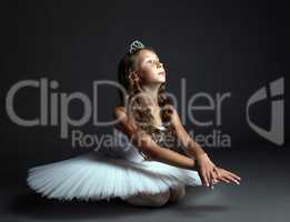 Image of pensive young ballerina dancing in studio