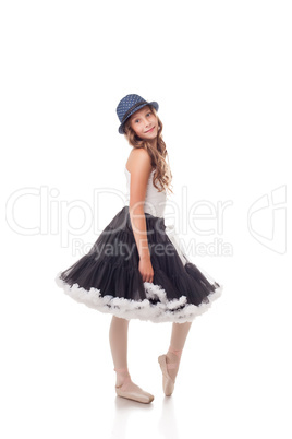 Pretty ballet dancer posing in dress and hat