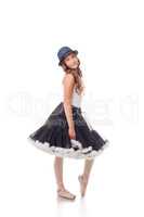 Pretty ballet dancer posing in dress and hat