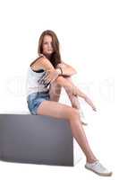 Image of athletic young girl sitting on cube