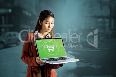 Composite image of smiling businesswoman showing a laptop