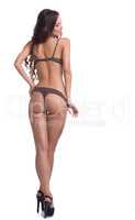 Rear view of happy slim model posing in lingerie