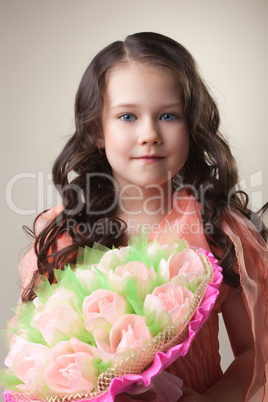 Lovely young girl with bouquet of paper tulips