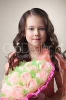 Lovely young girl with bouquet of paper tulips
