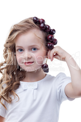 Pretty freckled girl posing with cherries