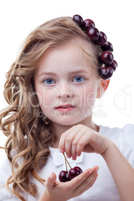 Freckled girl with cherries posing at camera