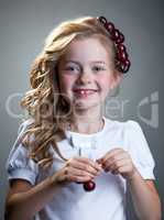 Laughing freckled girl posing with cherries