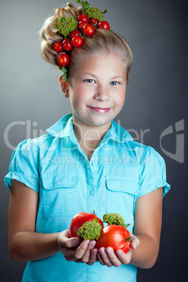 Smiling girl posing with wreath of cherry tomatoes