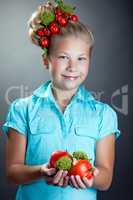 Smiling girl posing with wreath of cherry tomatoes