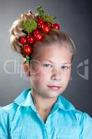 Portrait of cute girl with wreath of tomatoes