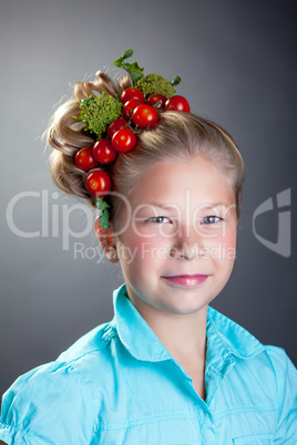Lovely little girl posing with wreath of tomatoes