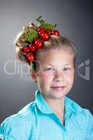 Lovely little girl posing with wreath of tomatoes