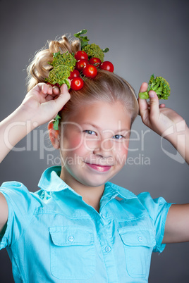 Cheerful girl posing with horns made of broccoli