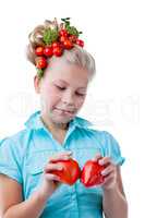 Thoughtful little girl puts heart of tomatoes
