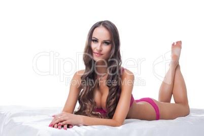 Beautiful busty woman posing lying in studio