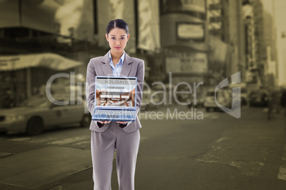 Composite image of portrait of a businesswoman showing a noteboo