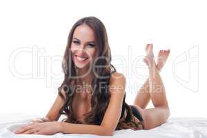 Cheerful beautiful woman posing lying in studio