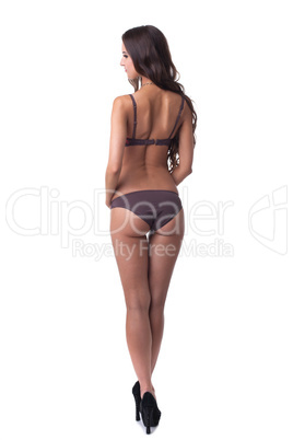 Rear view of slim woman posing in panties and bra