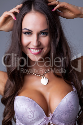 Portrait of smiling sexy woman posing in bra
