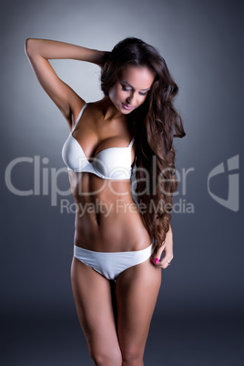 Beddable tanned woman posing in white lingerie