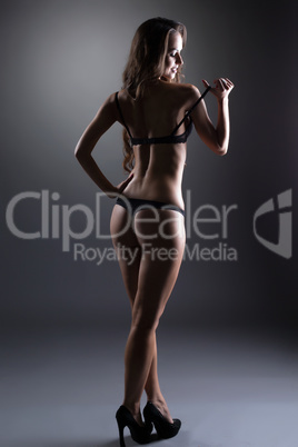 Flirtatious underwear model posing back to camera