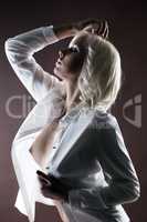 Hot platinum blonde posing topless in white blouse