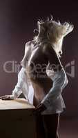 Passionate naked woman posing in studio