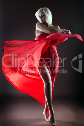 Graceful blonde dancing naked with red cloth