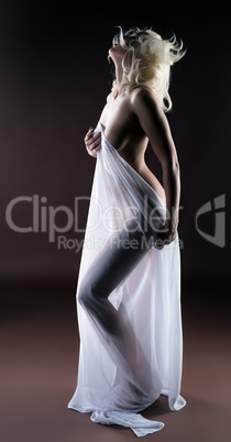 Studio shot of horny blonde posing with cloth