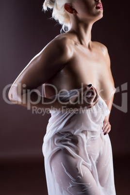 Seductive nude girl posing in wet dress, close-up
