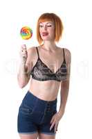 Pretty woman licking while looking at lollipop