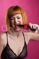 Cute redhead girl opens bottle by her mouth