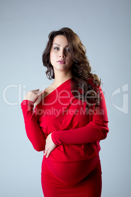 Attractive pregnant woman posing at camera