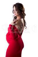 Charming pregnant woman posing in elegant dress